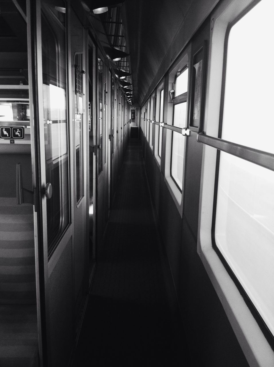 indoors, the way forward, architecture, diminishing perspective, built structure, empty, railing, absence, transportation, vanishing point, corridor, ceiling, narrow, long, no people, architectural column, in a row, day, illuminated, flooring