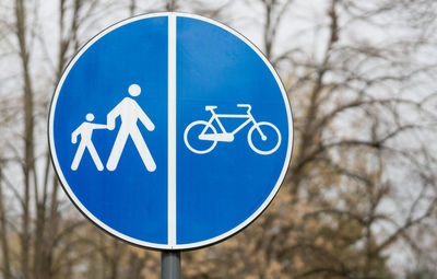 Close-up of road sign against trees