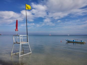 Lifeguard hut in sea against sky