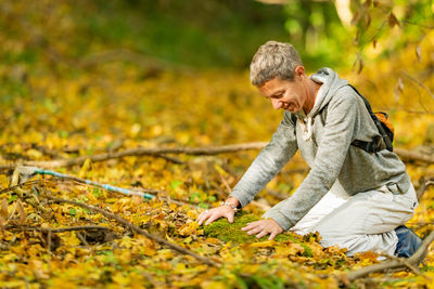 Female hands touching the ground, connecting to earth, grounding concept