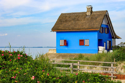 House on field against sky