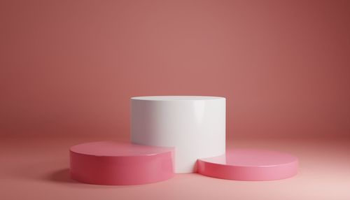 Close-up of pink candle over white background