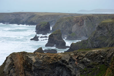 Scenic view of rock formation and sea against sky