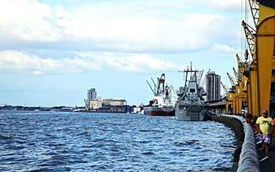 Boats in sea with buildings in background