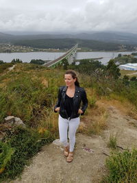 Woman on mountain against sky