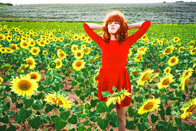 Portrait of smiling girl standing on field