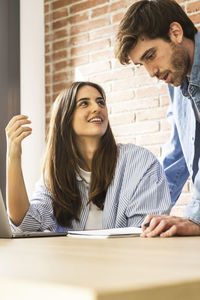 Female friends working at office