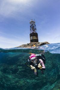 Young woman scuba diving in sea