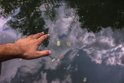 Reflection of man on water in lake