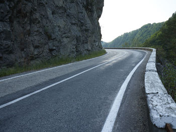 Surface level of empty road against mountain