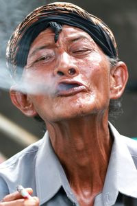 Portrait of man exhaling smoke