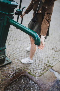 Low section of child standing on footpath