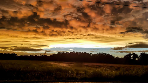 Scenic view of silhouette landscape against dramatic sky