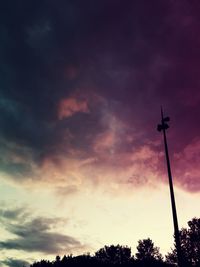 Low angle view of silhouette trees against dramatic sky