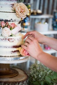 Hands of woman decorating  cake 