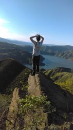 Full length of man standing on mountain against clear sky