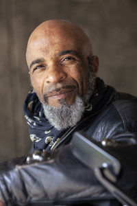 Portrait of smiling mature biker in leather jacket