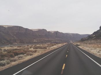 Empty road against sky