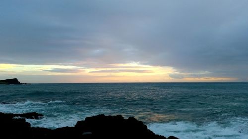 Scenic view of sea against cloudy sky