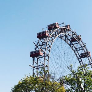 Low angle view of ferris wheel against clear sky