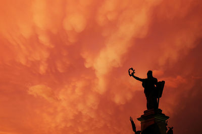 Low angle view of statue against sky during sunset