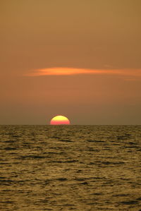 Scenic view of sea against orange sky