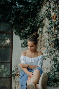 Young woman sitting outdoors