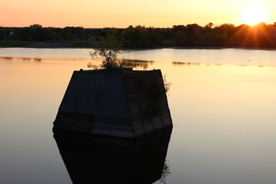 Scenic view of river at sunset