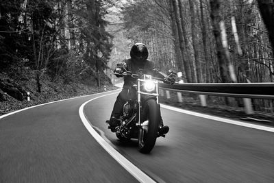 Man riding motorcycle on road