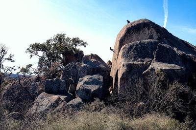 Low angle view of rock formation on land against sky