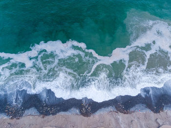 High angle view of waves splashing on shore