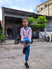 Portrait of boy against building