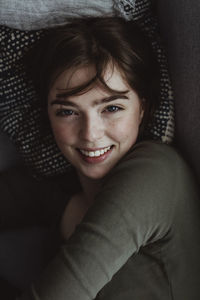 Portrait of smiling woman on sofa