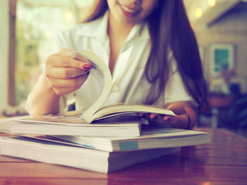 Close-up of woman reading book