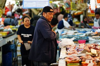 Men standing at market stall