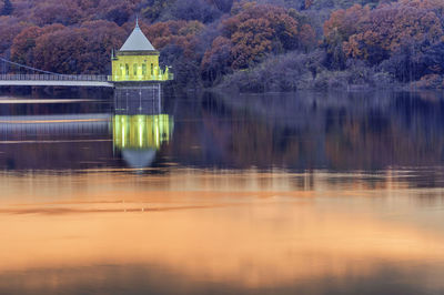 Reflection of trees in lake against sky