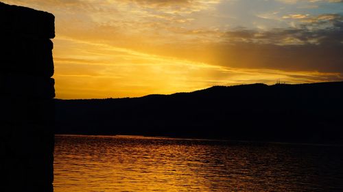 Scenic view of lake against romantic sky at sunset