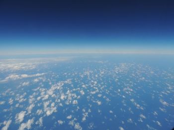 Aerial view of sea against blue sky