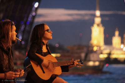 Young woman photographing at night