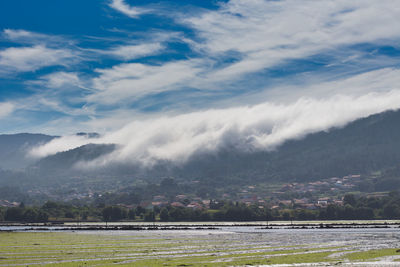 A sea of white clouds going down the mountains to the village of noia in galicia, 