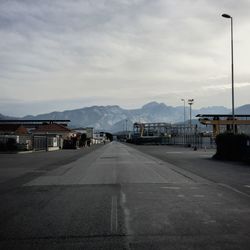 Empty road against cloudy sky