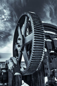 Low angle view of machine part against sky