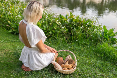 Rear view of boy picking plants