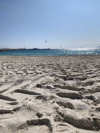 Scenic view of beach against clear sky