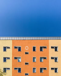 Low angle view of building against clear blue sky