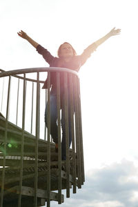 Low angle view of woman against sky