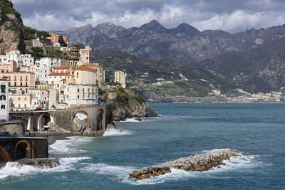 Scenic view of sea and mountains against sky