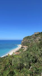 Scenic view of sea against clear blue sky