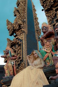 Low angle view of statue against building