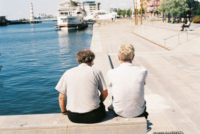 Elderly men sitting by sea